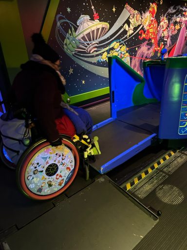 a wheelchair user is using the ramp to enter the ride vehicle