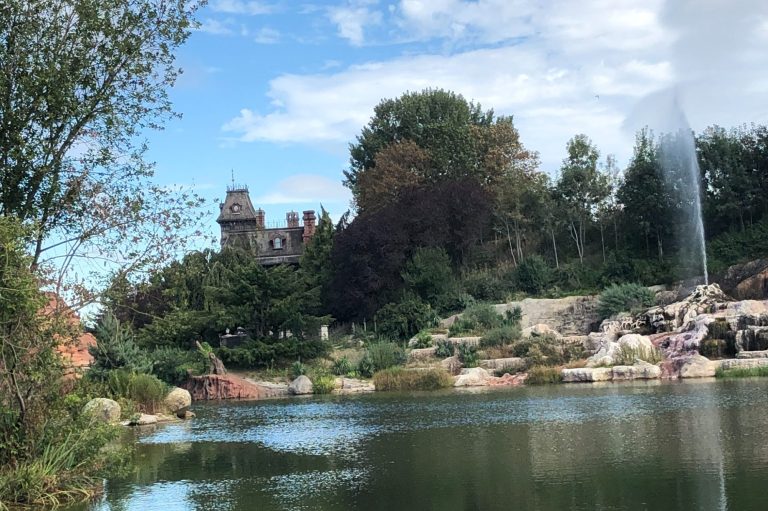 Image showing the view of Phantom Manor with the lake river and a geyser in the foreground