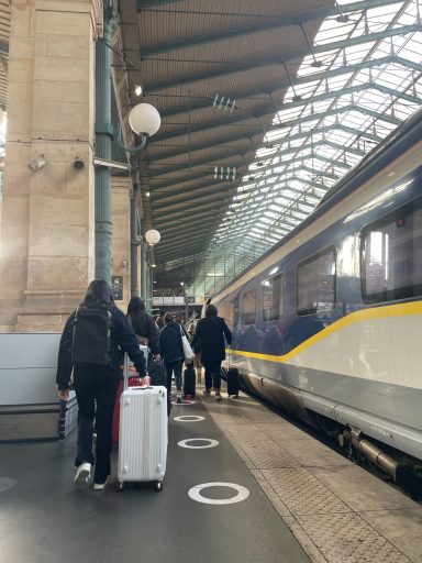 Train on a platform with passengers departing along the platform