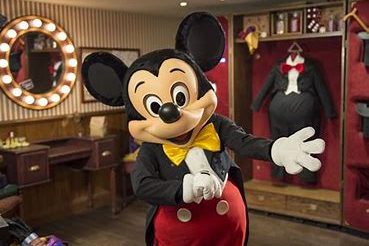 Mickey in his classic red and black outfit inside the room in Meet Mickey Mouse, there is a dressing table and wardrobe behind him