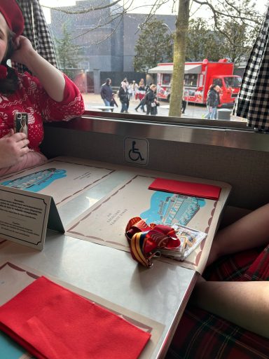 image of a diner table next to a window with a wheelchair symbol above it