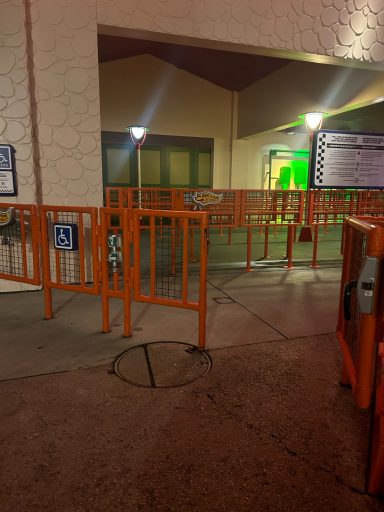 Image shows some orange metal gates and fencing