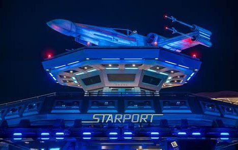 the starport building illuminated with blue light at night