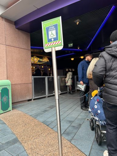 Image of a sign with a green background and a wheelchair symbol