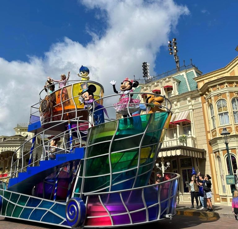 Image shows a colourful float on main street featuring Disney characters 