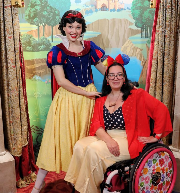 Image showing a brunette wheelchair user sat next to snow white