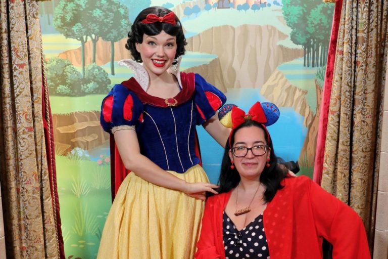 Jody is seated and wearing snow white ears, snow white is standing next to her