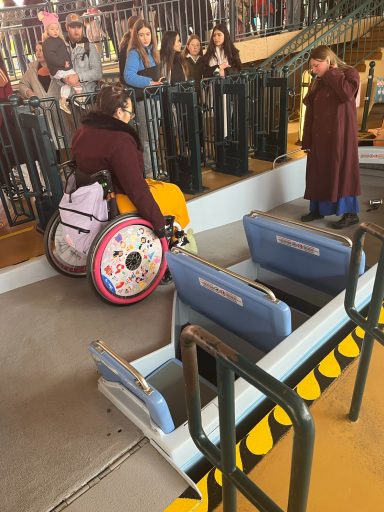 A wheelchair user going down the ramp on the boat