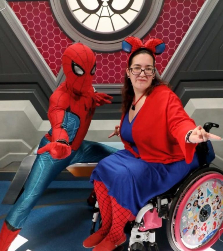 Image of Jody posingseated in her chair, drressed in a Spiderman disneybound, meeting and posing with spider-man