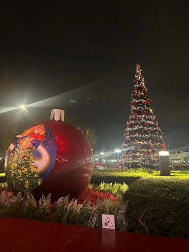 There is a christmas tree and in the foreground a large oversized bauble featuring captain marvel