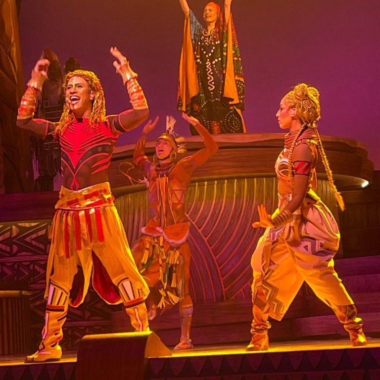 an image of Simba and Nala on stage in the lion king show