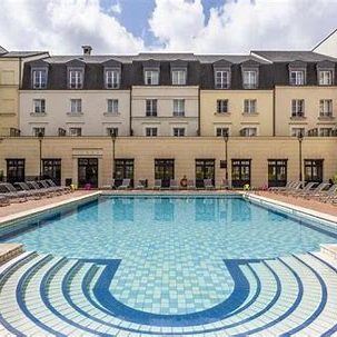 Image of the outdoor pool and building at adagio serris