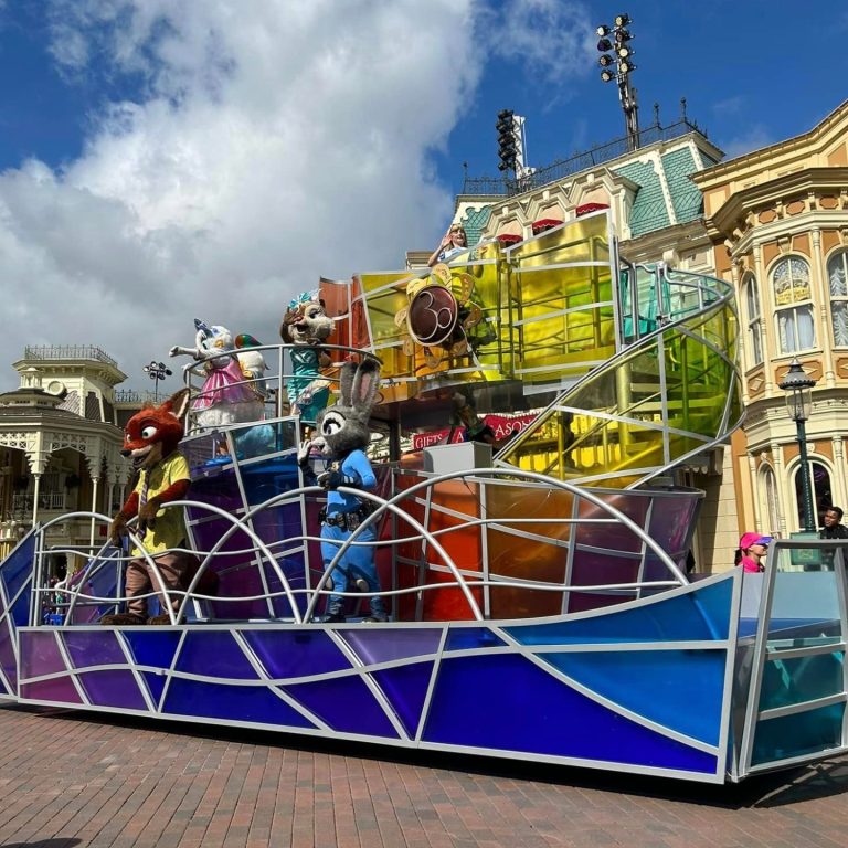 Image shows a colourful float on main street featuring Disney characters 