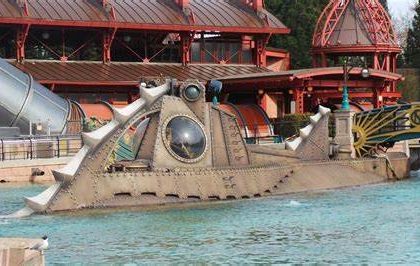 Image shows the nautilus submarine in the water at the side of hyperspace mountain