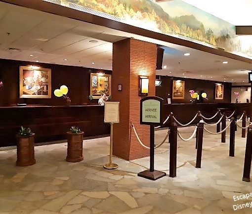 Image showing the reception area with flagstone flooring, wooden posts and ropes to form a queue and dark wood reception desks