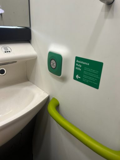 image showing a wall, sink and a green grab rail