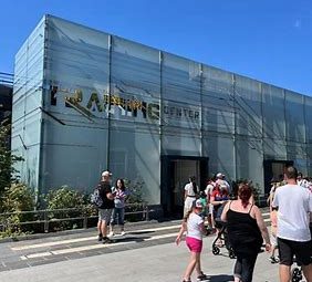 Image shows the exterior of the hero trainign centre, a modern looking frosted glass building with a sign stating training centre