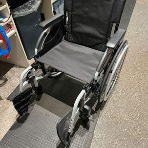 Image of a black wheelchair with large rear wheels and push rims to allow self propelling of the chair