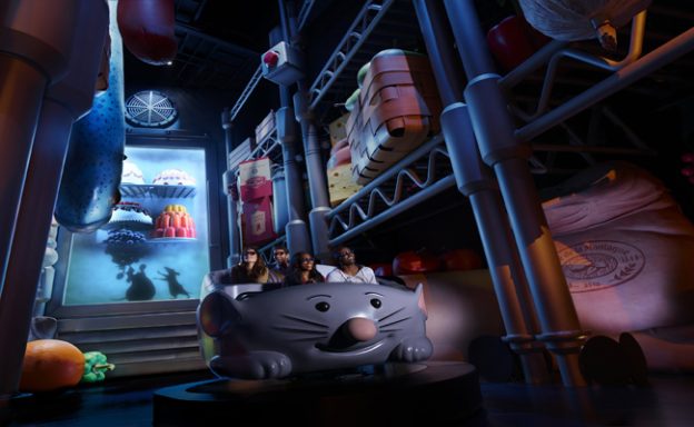 Image shows the rat shaped ride vehicle surrounded by an oversized kitchen including a fridge of food