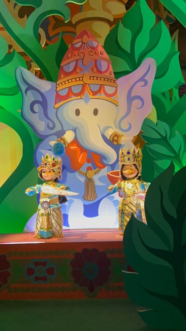 some dolls in indian inspired outfits in front of an elephant