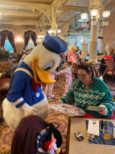 Donald is looking at the spoke cover for my wheels which I am holding in my hand