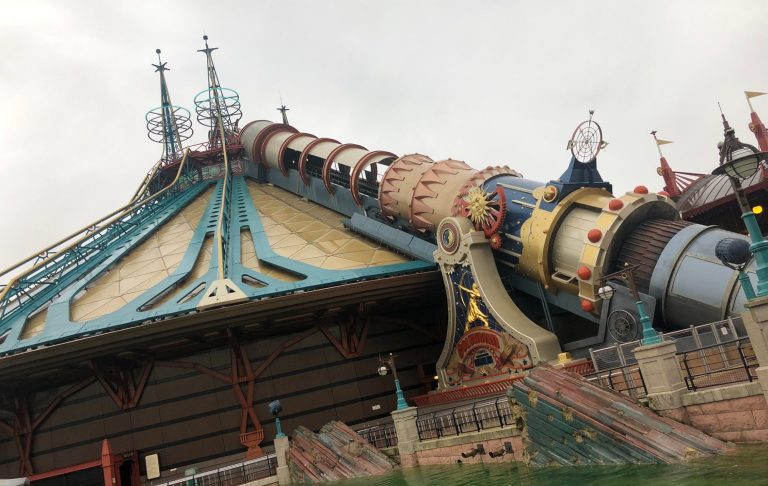 Photo of the exterior of the ride which is conical with a cannon positioned aiming for the top, it is jules verne inspired