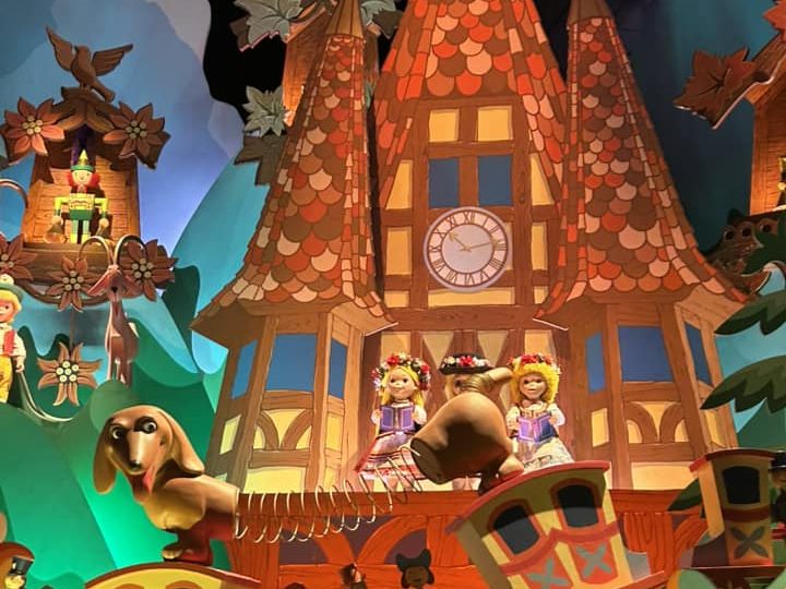 Image showing a scene from it's a small world featureing swiss style cottage and slinky dog