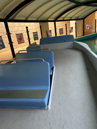 interior of a blue boat with grey non slip flooring was a ramp and some bench seats