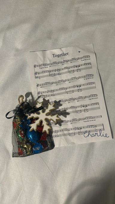 A sheet of music headed with Together and an organza bag decorated with a wooden snowflake