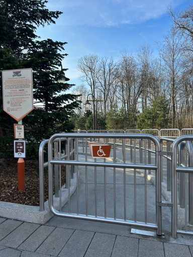 A metal gate with a wheelchair symbol