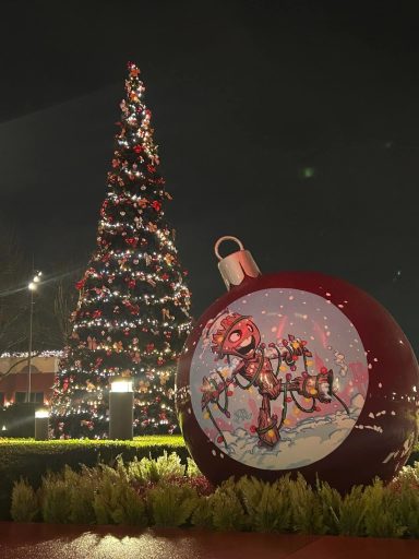 There is a christmas tree and in the foreground a large oversized bauble featuring groot