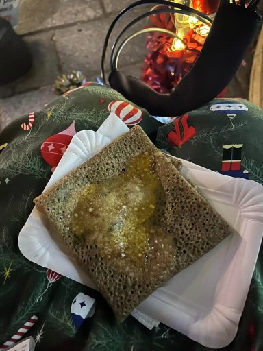 Image of a buckwheat crepe folded into a square on a paper plate