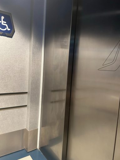 Image of silver lift doors with a wheelchair symbol next to them