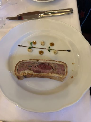 I,age of meat wrapped in pastry served on a white plate