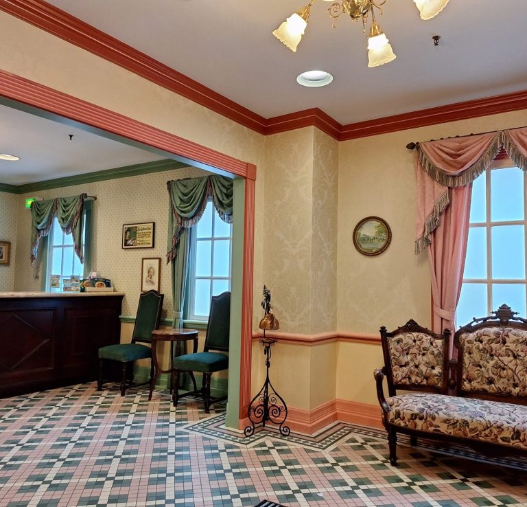 Image of the lobby area of the first aid centre which has a tiled floor and draped curtains, it is Victorian style