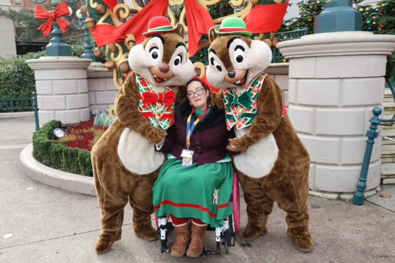 Jody is seated in her wheelchair between chip and dale