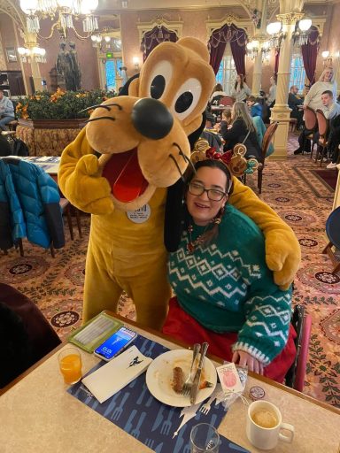 Pluto standing with his arm around my shoulder, i'm seated in my chair