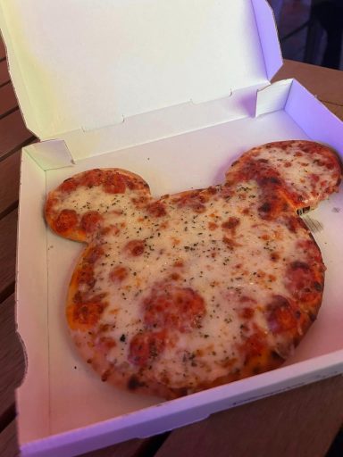 Image shows a cheese pizze which is shaped like mickey mouse