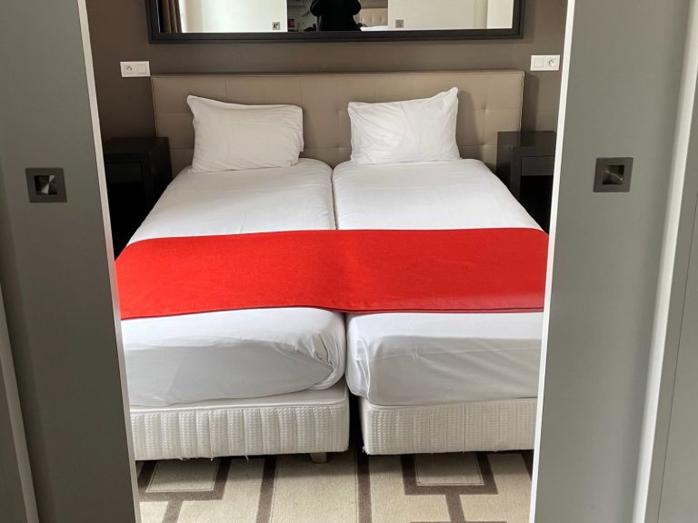 Image showing twin beds which are close to each other and have a mirror above them