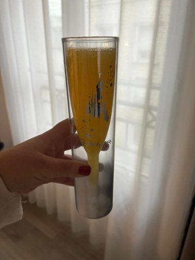 A disneyland paris champagne flute filled with bucks fizz