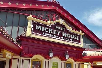 Exterior of the meet mickey house which is red and cream with an ornate sign stating Meet Mickey Mouse