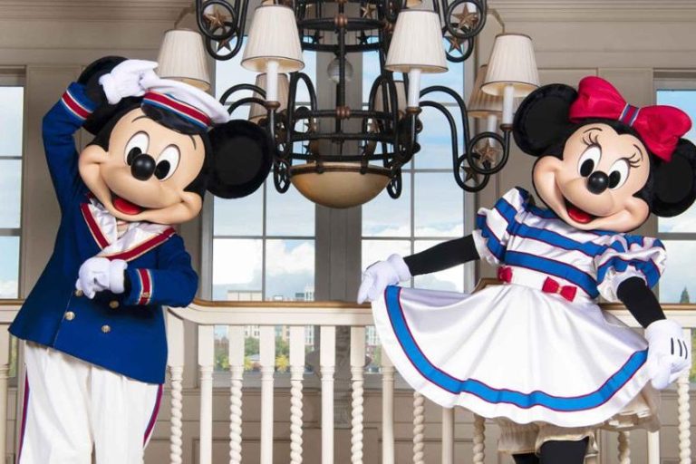 Mickey and Minnie mouse in nautical white and blue outfits in the newport bay hotel lobby