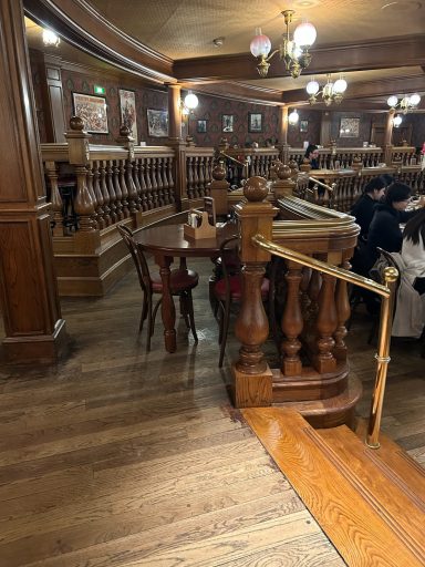 a dark brown table near some wooden railings and some steps