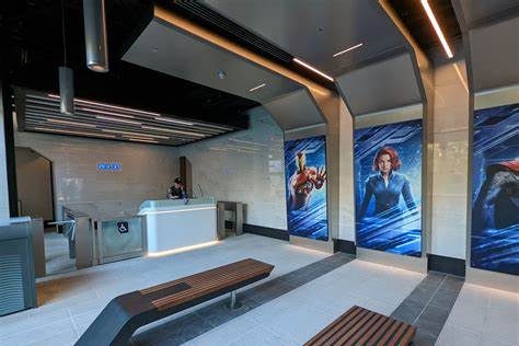 waiting area for the hero training centre with benches, smooth floors and large posters of marvel superheroes