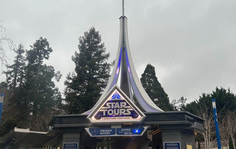 Photo of the exterior of the ride showing a sign for Star Tours