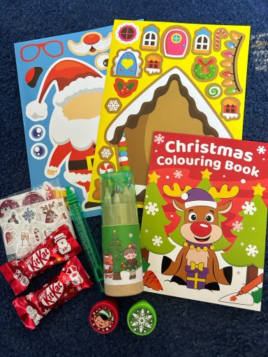 Image showing a christmas colouring book, colouring pencils, stamps, stickers and some chocolate