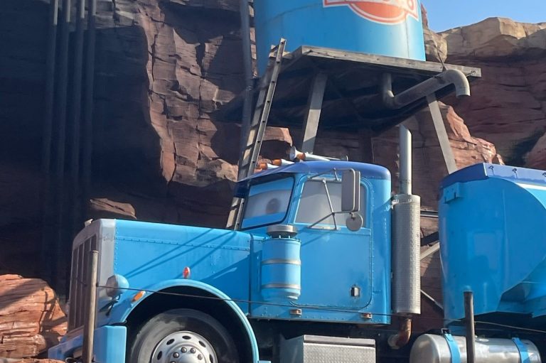 Image of a blue tanker truck with a rocky background